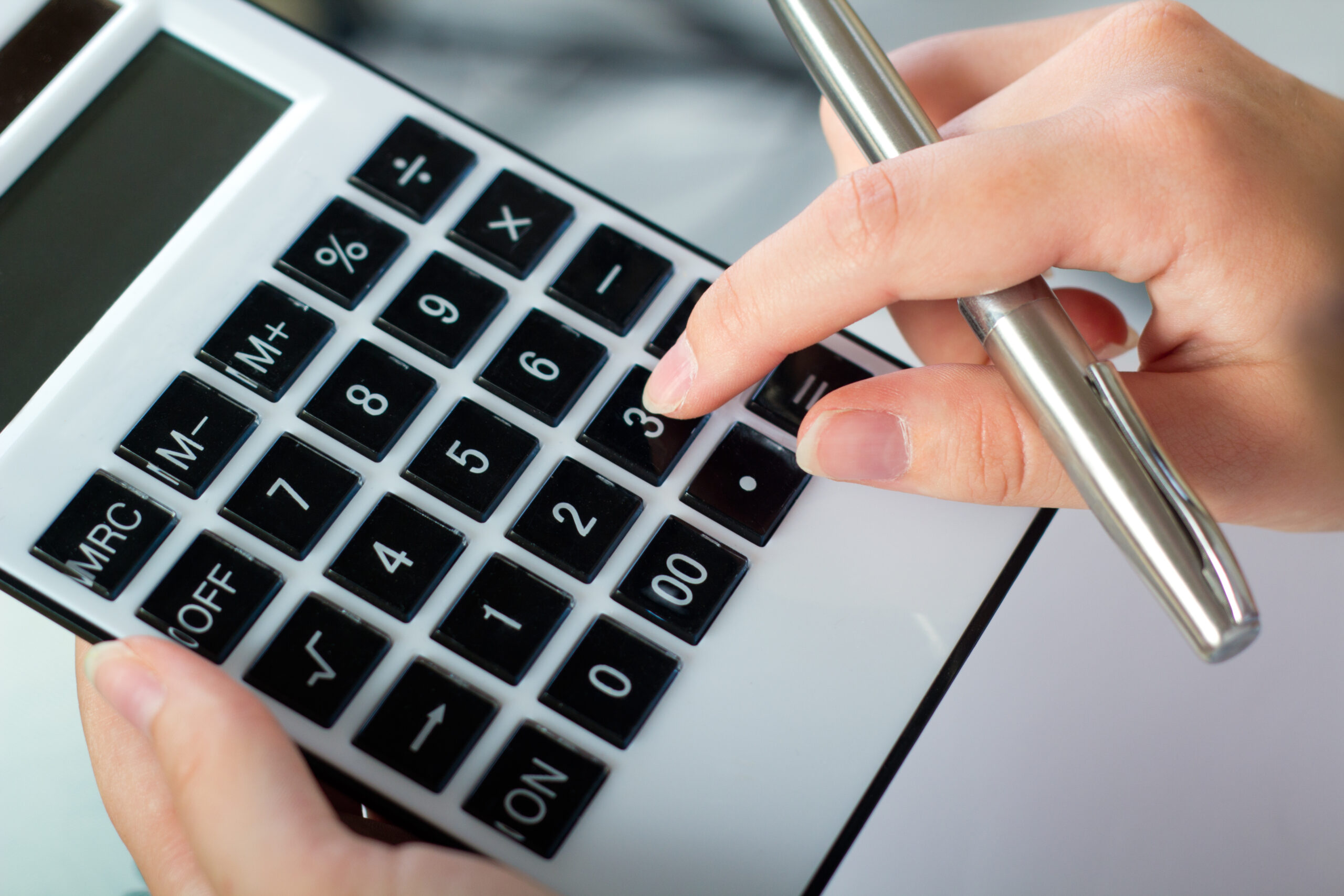 portrait of woman with a calculator and pen